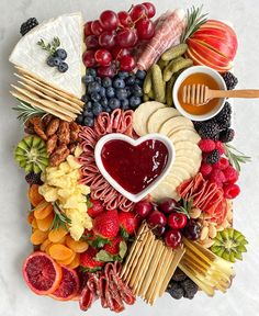 a platter filled with fruit, cheese and crackers