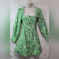 This Listing Is For A Nwt Blackmilk Animal Crossing New Horizons Isabelle Gingham Pilgrim Dress. It Has Isabelle's Signature Gingham Print With Little Isabelles, Leaves And Daisies Sprinkled About. Its A Size 8 And Measures About 15.5'' From Pit To Pit, About 18'' From Pit To Cuff And About 33'' From The Top Of The Back Of The Collar And To The Bottom Him. It Has A Zipper Closure In Back, Cute, Non-Fuctional Buttons On Front And Functional Buttons On The Cuffs. If You Have Any Questions Or Would Fitted A-line Dress For Picnic, Green Mini Dress For Picnic, Green Square Neck Dress For Picnic, Green Cotton Mini Dress For Picnic, Spring Cotton Plaid Long Sleeve Dress, Spring Long Sleeve Cotton Plaid Dress, Spring Long Sleeve Plaid Cotton Dress, Spring Plaid Dress For Garden Party, Plaid Dress For Spring Garden Party