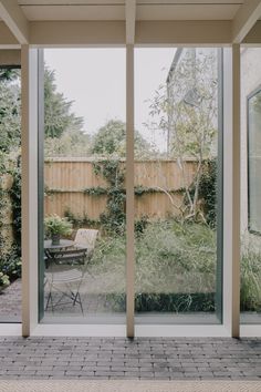 an outdoor patio with sliding glass doors leading into the back yard