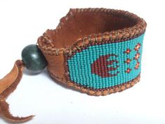 MEN'S Wide Cuff Wetlands Native American Inspired Beaded | Etsy Traditional Handmade Brown Beaded Bracelets, Traditional Handmade Brown Cuff Bracelet, Traditional Handwoven Adjustable Cuff Bracelet, Adjustable Handwoven Traditional Cuff Bracelet, Wooden Bracelets, Native American Clothing, Deer Hide, Friendship Bracelets With Beads, Native American Design