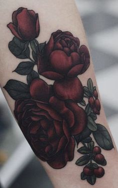 a close up of a person's arm with flowers on it