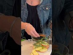 a woman is cutting apples with a knife