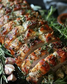 sliced pork with herbs and garlic on a platter