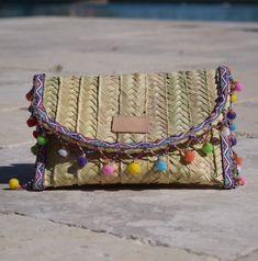 Penelope Multicolor Pom Pom Trim Straw Clutch - Oriana Lamarca LLC Pom Pom Clutch, Diy Shoulder Bag, Diy Straw, Straw Beach Bag, Straw Clutch, Handmade Purses, Pom Pom Trim, Craft Bags, Metal Clay