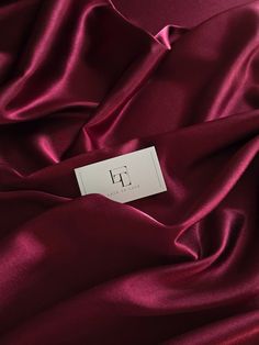 a close up view of a red satin fabric