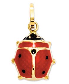 a red and black lady bug charm on a white background