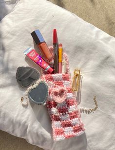 the contents of a purse laid out on top of a white cloth covered in crochet