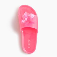 a pink slipper with a flower on the front and bottom part is shown against a white background