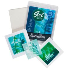 four cards in a plastic case with green and blue designs on them, including one for speedball