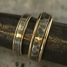 Bands Mixed Metal Rings Rustic Wedding Bands Mens Wedding Rings Womens Wedding Bands Two Tone Rings Hammered Wedding Set Paragon Blazer Arts Our Paragon Design is one of our most popular. It's rugged yet elegant, and now we have the perfect set for a couple who can be described that same way. To create your bands we will first securely solder full round 14K gold stock to both sides of a piece of rectangular silver stock. We then hand form this joined material into a ring just for you. The 14K go Handmade Yellow Gold Stackable Wedding Rings, Handmade Gold Bridal Sets For Wedding, Silver Hammered Wedding Jewelry, Gold Hammered Stackable Wedding Rings, Hammered Silver Jewelry For Wedding, Gold Hammered Stackable Rings For Wedding, Handmade Gold Stackable Rings For Wedding, Adjustable Wedding Ring Jewelry, Adjustable Ring Detailed Jewelry For Weddings