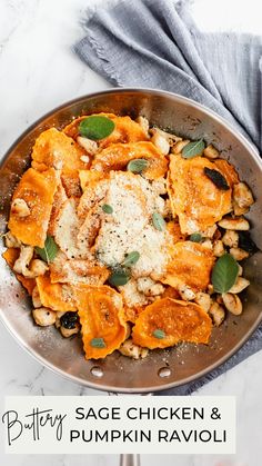 a skillet filled with pasta, chicken and pumpkin ravioli on top of a marble counter