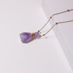 PLEASE NOTE: Our crystal stones are natural minerals and each crystal is unique. The internal ice cracks, pits, mineral points, and color differences of natural crystals are all formed naturally and are normal phenomena, which will not affect the efficacy, beauty and value of the crystal at all.Delight your senses every day with a natural aromatherapy amethyst pendant. Simply unscrew the top and place in your favourite essential oil or perfume. You can add drops of essential oils into the bottle Elegant Amethyst Crystals For Healing, Quartz Crystal Necklace With Raw Stone For Healing, Healing Natural Stone Crystal Necklaces, Healing Mineral Crystal Necklace With Natural Stones, Healing Mineral Crystal Gemstone Necklace, Purple Natural Stones Crystals As A Gift, Lavender Crystal Necklaces With Natural Stones For Gift, Lavender Crystal Necklace With Natural Stones For Gift, Healing Mineral Crystal Necklace With Stones