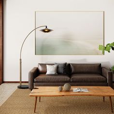 a living room with a couch, coffee table and large painting on the wall above it