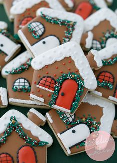 gingerbread houses decorated with icing and sprinkles on a green surface