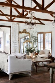 a living room filled with furniture and a chandelier