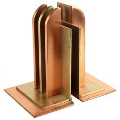 a pair of bookends made out of wood and metal