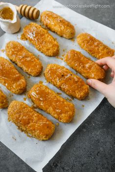 chicken tenderies on parchment paper with honey