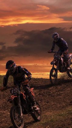 two motorcyclists are racing on the dirt track at sunset or sunrise time