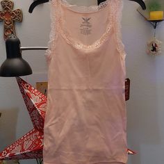 Baby Pink Camisole/ Tank Top With Lace Detail. Perfect For Layering. 94% Cotton, 6%Spandex. Brand New Never Worn. Feminine Stretch Sleeveless Tank Top, Spring Racerback Stretch Camisole, Spring Stretch Racerback Camisole, Stretch Racerback Camisole For Spring, Fitted Vest Tank Top For Loungewear, Casual Tops With Lace Trim And Tank Straps, Scoop Neck Tops With Lace Trim And Stretch, Feminine Stretch Cami Top, Casual Tank Top With Lace Trim