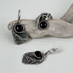 Handmade sterling silver jewelry set with natural round onyx. Black gemstone ring and earrings for women. Made in Armenia! Abstract ring and earrings made of 925 sterling silver are designed with a creative and unconventional shape. It's adorned with a smooth, glossy round onyx stone, creating a visually captivating contrast with the silver. This design makes it an unconventional jewelry piece that's perfect for those who appreciate contemporary, artistic accessories. All our jewelry is crafted Elegant Handmade Onyx Jewelry, Black Sterling Silver Hand Forged Jewelry, Black Hand Forged Sterling Silver Jewelry, Hand Forged Black Sterling Silver Jewelry, Elegant Handmade Sterling Silver Jewelry Sets, Elegant Sterling Silver Jewelry Sets With Oxidized Finish, Texture Jewelry, Abstract Jewelry, Silver Jewellery Sets