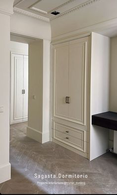 an empty room with white walls and cabinets