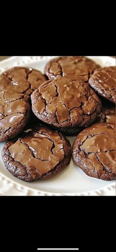 chocolate cookies are on a white plate with the words