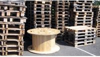 several wooden pallets stacked on top of each other with a table in the middle