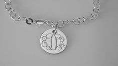 "This lovely sterling silver bracelet features a 17 gauge, high polish sterling silver 1/2\" diameter disc on a sterling silver 7\" chain, with a lobster claw clasp. I can engrave a monogram, one to three initials, or a name, date or word up to 10 characters. The back of the disc can also be engraved with up to 10 characters The bracelet will be delivered to you in a gift box. This style is also available in 8\" Length: https://www.etsy.com/listing/950524673/custom-engraved-monogram-or-initial? Classic Engraved Sterling Silver Charm Bracelet, Engraved Link Sterling Silver Bracelet Adjustable, Classic Personalized Name Bracelet, Classic Round Charm Bracelet With Polished Finish, Stamped Silver Round Disc Jewelry, Engraved White Gold Sterling Silver Bracelet, Silver Stamped Round Disc Jewelry, Personalized Sterling Silver Jewelry With Oval Link, Personalized Sterling Silver Oval Link Jewelry