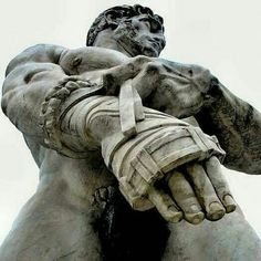 an image of a statue that looks like he is holding the arm of another man