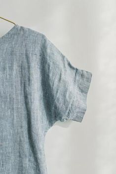 an old blue linen shirt hanging on a clothes line