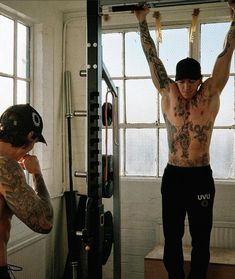 a man doing pull ups in front of a window