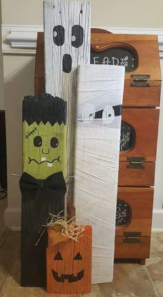 two halloween decorations made out of wood sticks