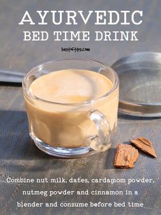 a cup of coffee with cinnamon on the side and text overlaying that reads, ayurvedic bed time drink combine nut milk dates, caramel powder, nutme power and cinnamon in a