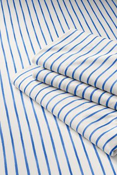 three blue and white striped sheets folded on top of each other