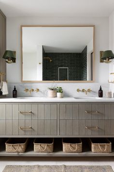 a bathroom with two sinks, mirrors and baskets