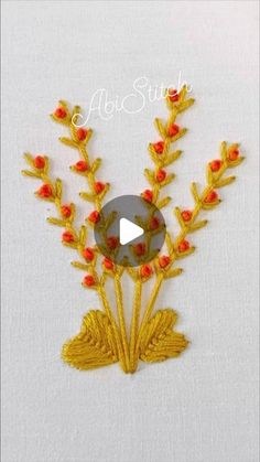 an embroidered piece with red flowers and yellow leaves on it, next to a video about how to sew