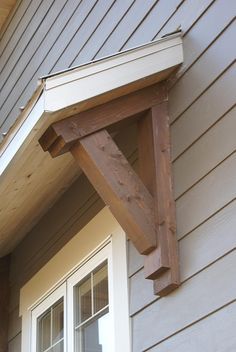 the corner of a house with a wooden window frame