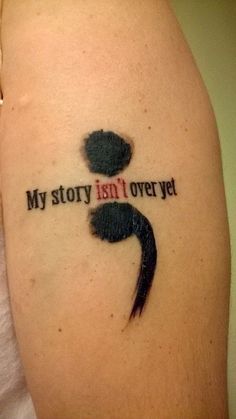 a person with a tattoo on their arm that says, my story isn't over yet