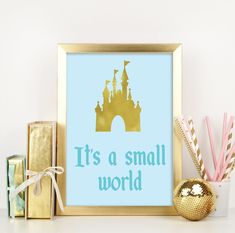 it's a small world framed art print in blue and gold with princess castle