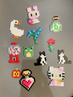 a bunch of pixelated magnets sitting on top of a refrigerator freezer next to each other