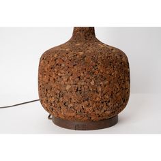 a lamp that is made out of cork and has a cord attached to the base