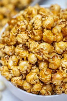 a white bowl filled with caramel popcorn