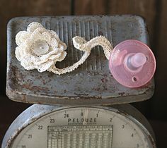 an old scale with a flower on it