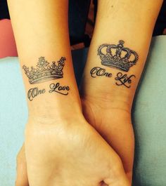 two people with matching tattoos on their arms, one is holding the other's hand