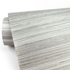 a close up view of a white and grey striped wallpaper