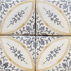 four tile designs in blue and white with gold accents