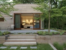 a house with steps leading up to the front door and patio in the back yard