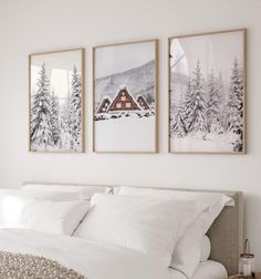 three framed pictures hang on the wall above a bed in a room with white sheets and pillows