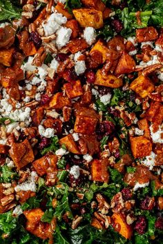 a salad with sweet potatoes, feta cheese and cranberries