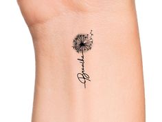 a small dandelion tattoo on the side of a woman's left ankle